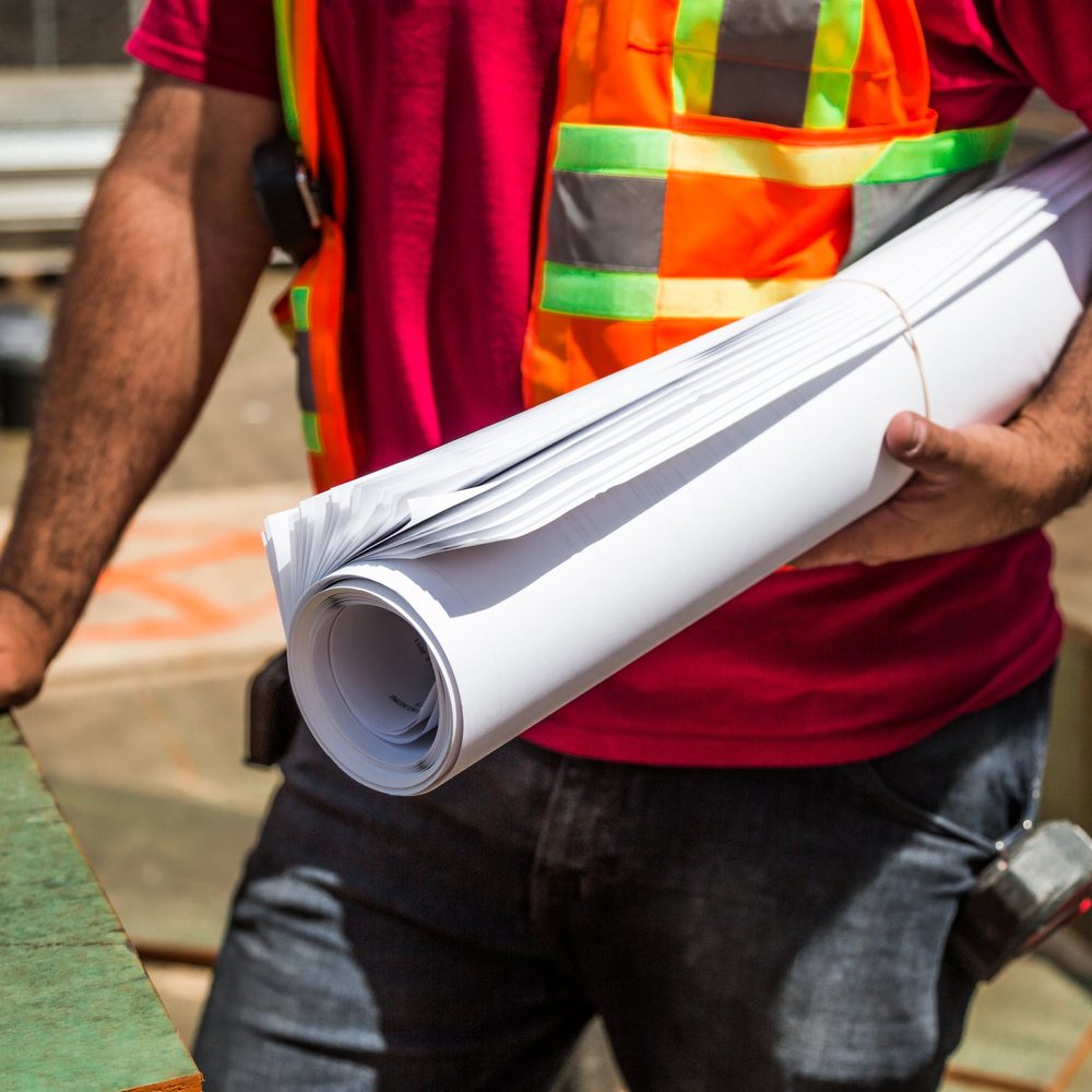 Plans de chantier sous le bras, lors d’une visite d’opération